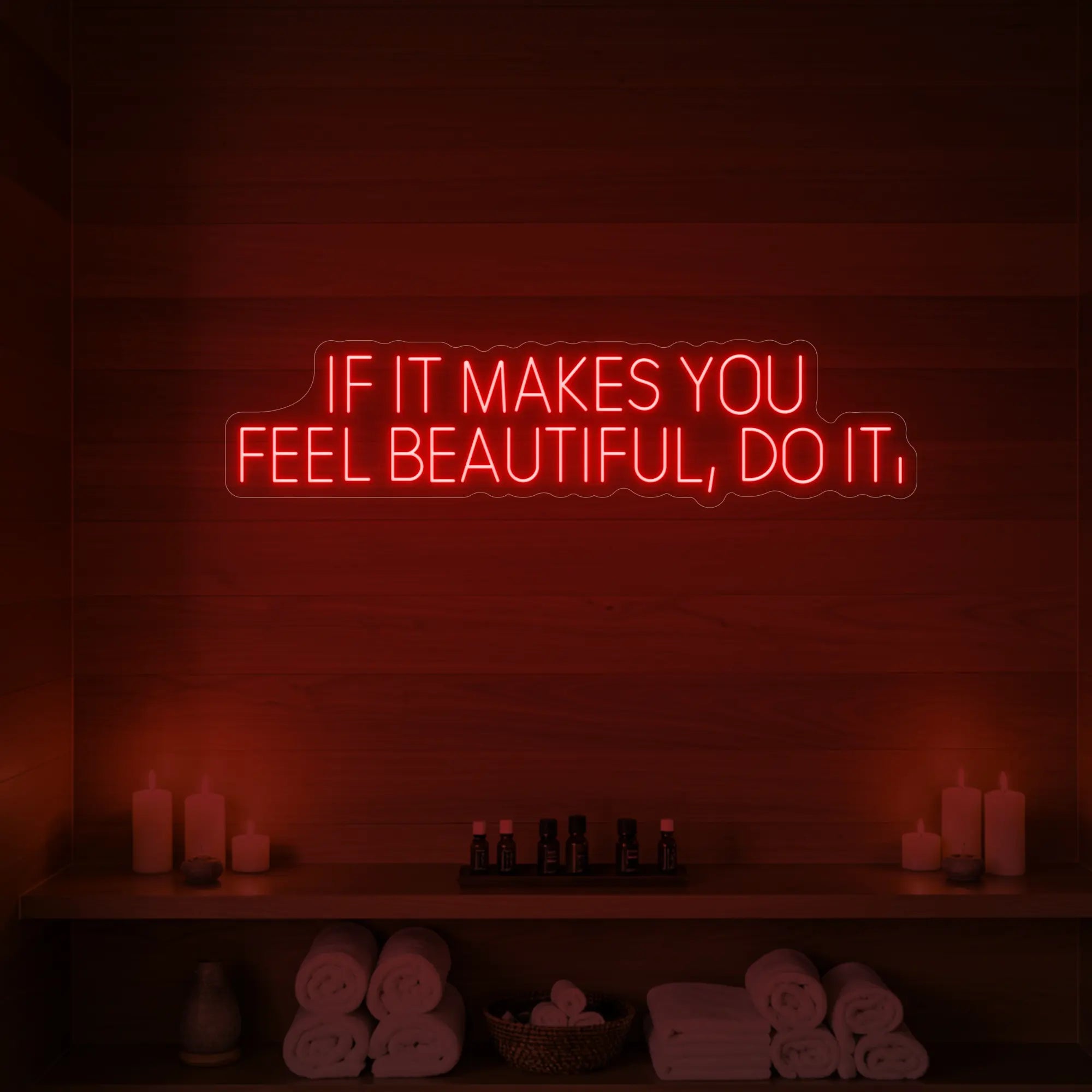 Photo of the 'IF IT MAKES YOU FEEL BEAUTIFUL, DO IT.' neon sign glowing in red against a styled interior wall.