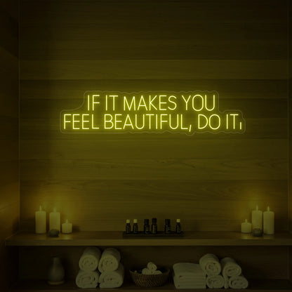 Photo of the 'IF IT MAKES YOU FEEL BEAUTIFUL, DO IT.' neon sign glowing in lemon yellow against a styled interior wall.