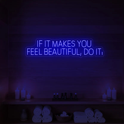 Photo of the 'IF IT MAKES YOU FEEL BEAUTIFUL, DO IT.' neon sign glowing in deep blue against a styled interior wall.