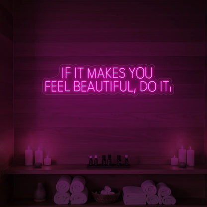Photo of the 'IF IT MAKES YOU FEEL BEAUTIFUL, DO IT.' neon sign glowing in light pink against a styled interior wall.