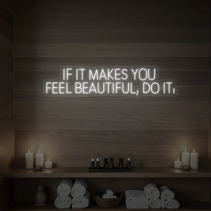 Photo of the 'IF IT MAKES YOU FEEL BEAUTIFUL, DO IT.' neon sign glowing in cool white against a styled interior wall.