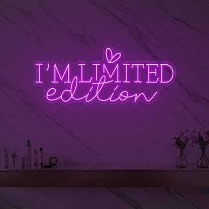 Photo of the 'I’M LIMITED edition' neon sign with a heart icon glowing in deep pink against a styled interior wall.