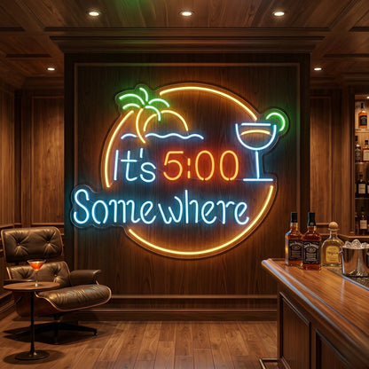 Photo of the 'It’s 5:00 Somewhere' neon sign glowing in multi-color against a styled interior wall.