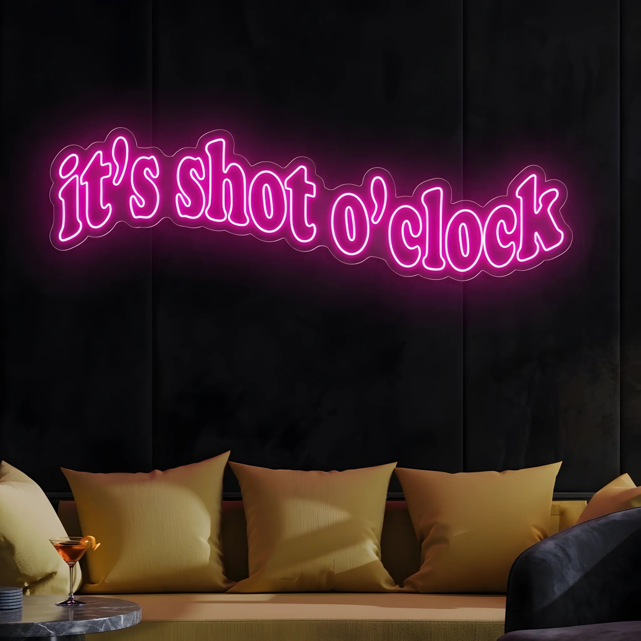 Photo of the 'It’s Shot O’Clock' neon sign glowing in deep pink against a styled interior wall.