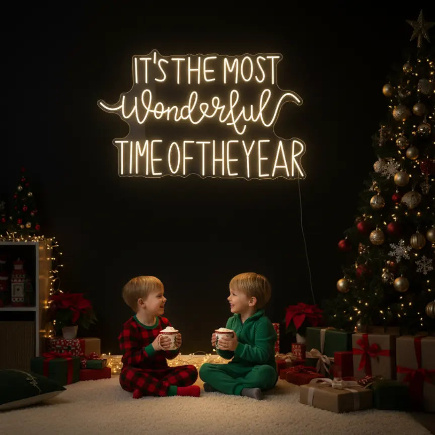 Photo of the 'It’s the Most Wonderful Time of the Year' neon sign glowing in warm white against a styled interior wall.