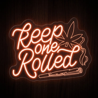 Keep One Rolled LED neon sign featuring handwritten quote with a cannabis leaf, rolled joint, and smoke accents on a clear acrylic backing.