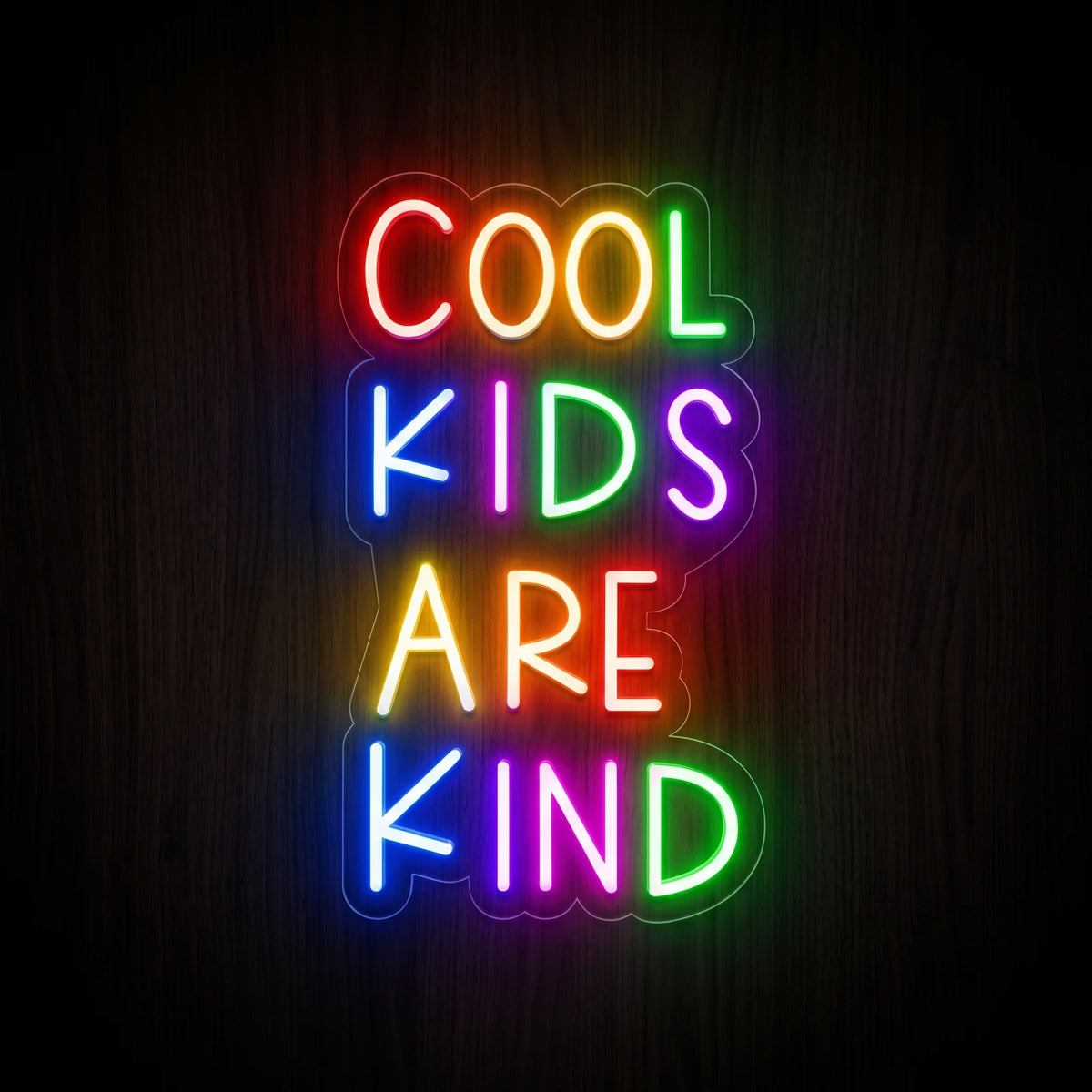 Cool Kids Are Kind LED neon sign featuring bright multicolor lettering on clear acrylic backing.
