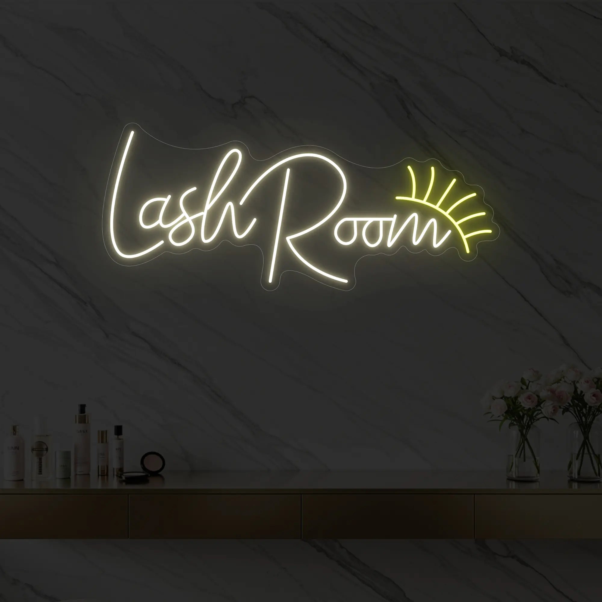Photo of the 'Lash Room' neon sign with an eyelash icon glowing in warm white against a styled interior wall.