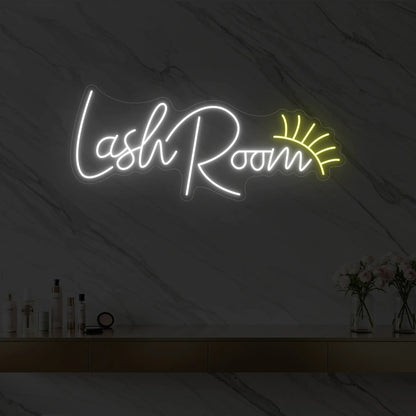 Photo of the 'Lash Room' neon sign with an eyelash icon glowing in cool white against a styled interior wall.