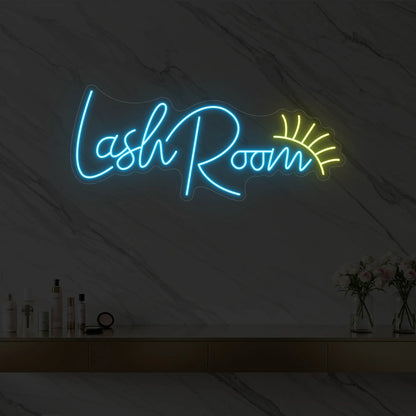 Photo of the 'Lash Room' neon sign with an eyelash icon glowing in ice blue against a styled interior wall.