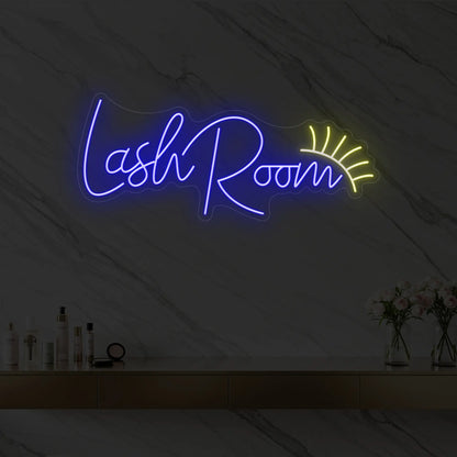 Photo of the 'Lash Room' neon sign with an eyelash icon glowing in deep blue against a styled interior wall.