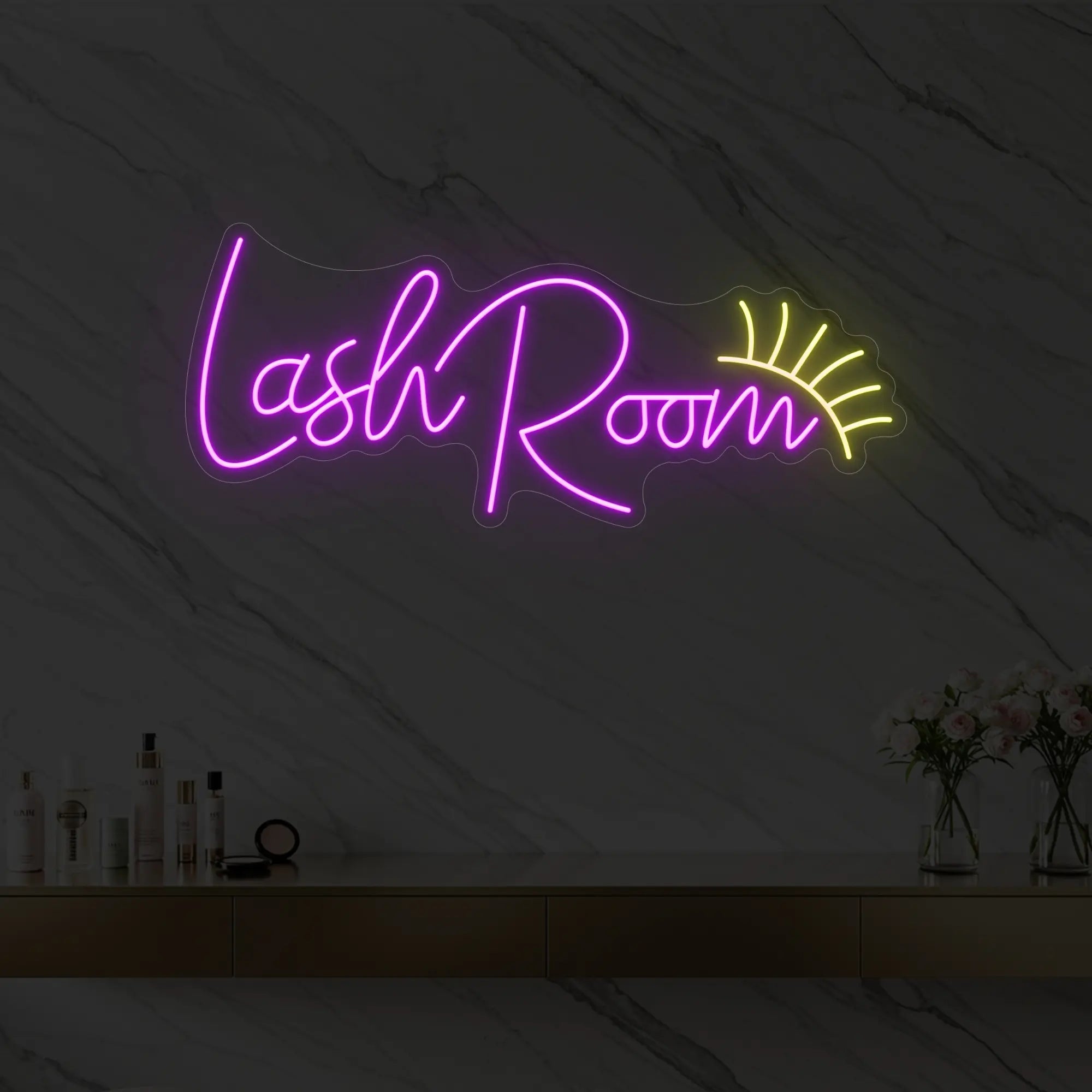 Photo of the 'Lash Room' neon sign with an eyelash icon glowing in deep pink against a styled interior wall.