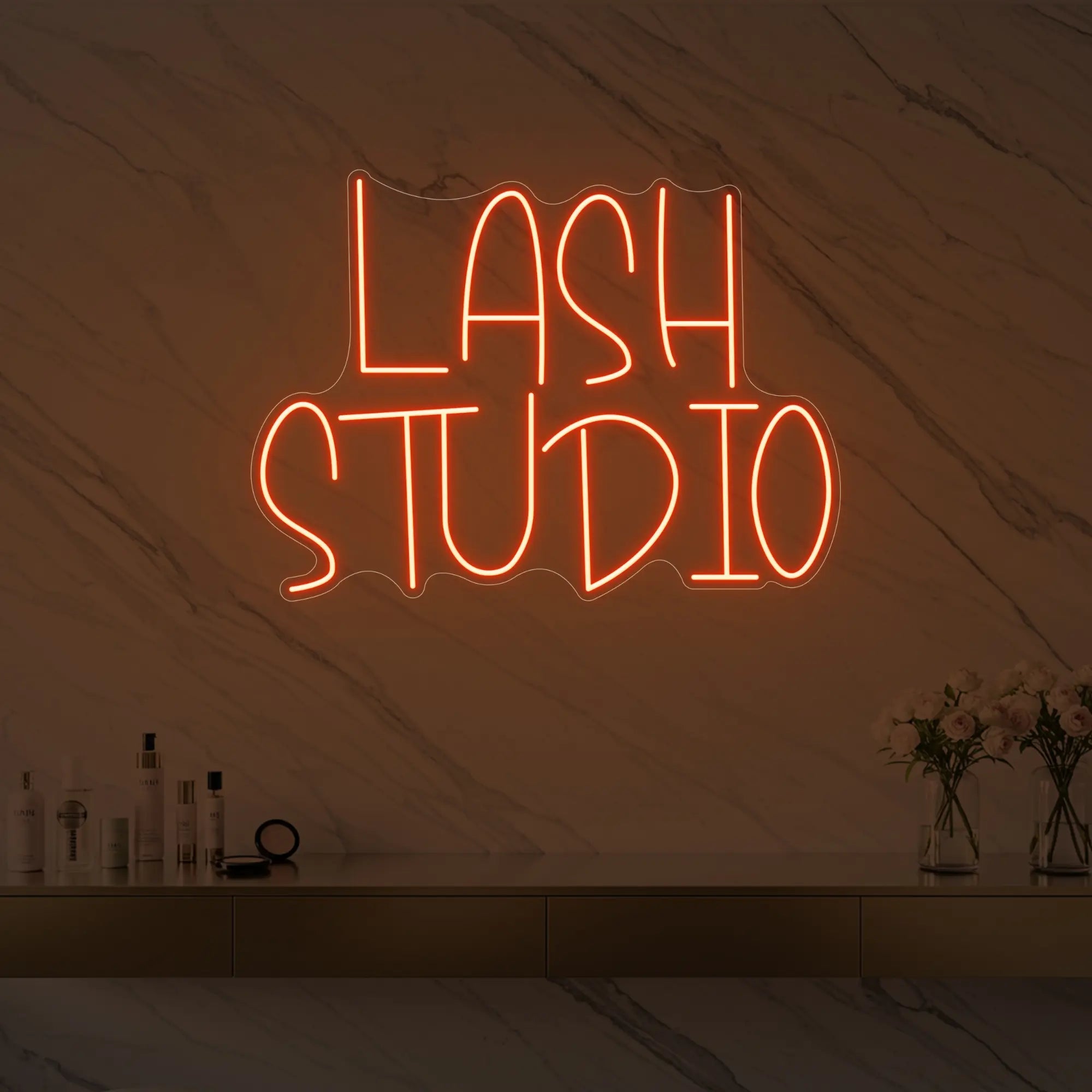 Photo of the 'LASH STUDIO' neon sign glowing in golden yellow against a styled interior wall.