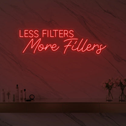 Photo of the 'LESS FILTERS MORE FILLERS' neon sign glowing in red against a marble wall.