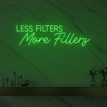 Photo of the 'LESS FILTERS MORE FILLERS' neon sign glowing in green against a marble wall.
