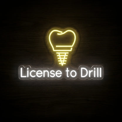 License to Drill LED neon sign featuring a golden-yellow dental implant screw shaped like a tooth above cool white License to Drill lettering on clear acrylic backing for dental clinic and dentist office wall decor.