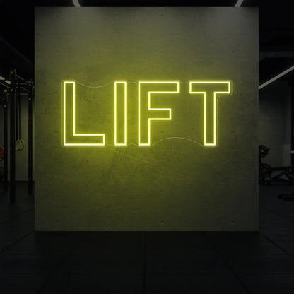 'LIFT' neon sign glowing in lemon yellow against a styled interior wall.

