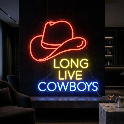 Photo of the 'Long Live Cowboys' neon sign glowing in multi-color against a styled interior wall.