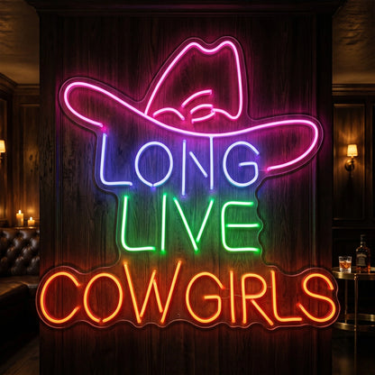 Photo of the 'Long Live Cowgirls' neon sign glowing in multi-color against a styled interior wall.