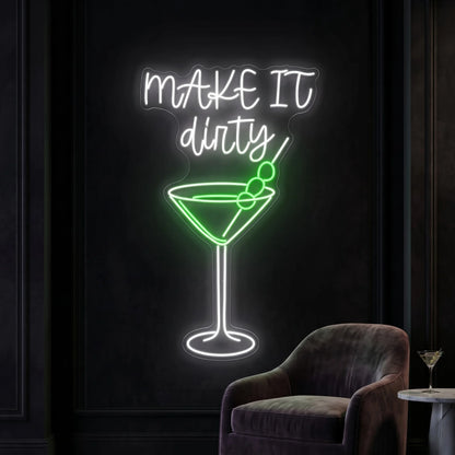 Photo of the 'Make It Dirty' neon sign glowing in multi-color against a styled interior wall.
