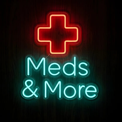 Meds & More LED Neon Sign featuring a glowing red medical cross above turquoise Meds & More lettering on clear acrylic backing against a dark wooden wall.