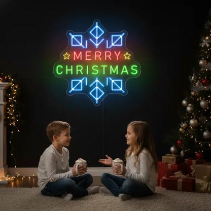 Photo of the 'Merry Christmas in a Snowflake' neon sign glowing in Multicolor against a styled interior wall.