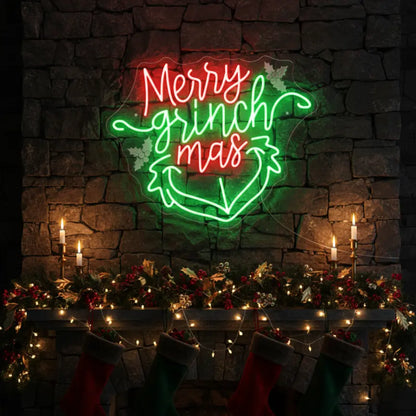 Photo of the 'Merry Grinchmas' neon sign glowing in multicolor against a styled interior wall.