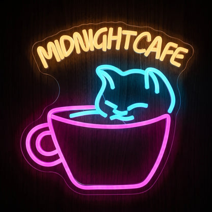 Midnight Cafe Cat LED Neon Sign featuring a blue cat peeking from a pink coffee cup with warm yellow Midnight Cafe lettering.