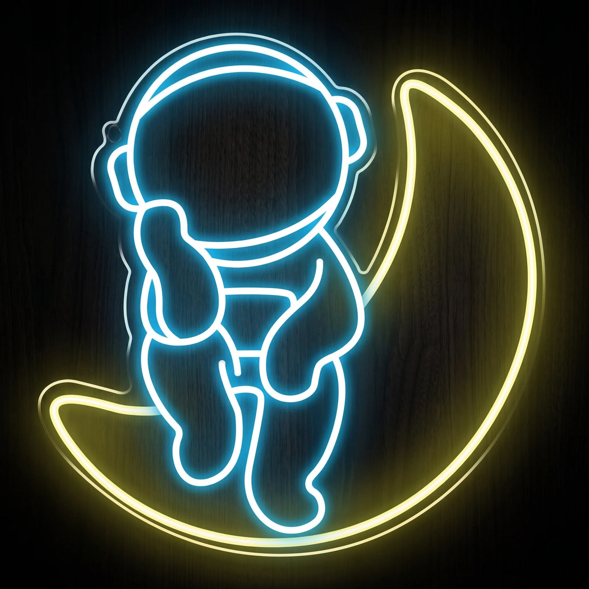 Moon Dreamer LED neon sign featuring a blue and white astronaut sitting on a glowing yellow crescent moon.