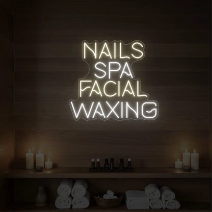 Photo of the 'Nails Spa Facial Waxing' neon sign glowing in warm white against a styled interior wall.