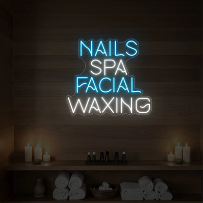 Photo of the 'Nails Spa Facial Waxing' neon sign glowing in ice blue against a styled interior wall.