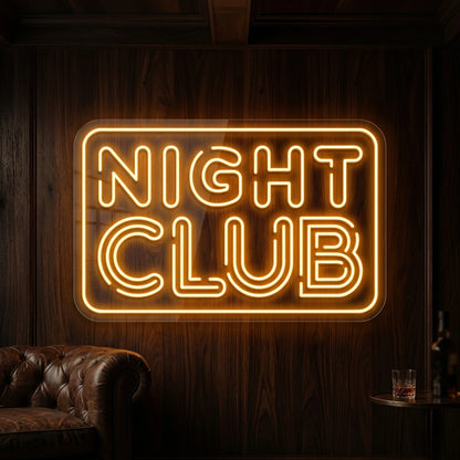 Photo of the 'Night Club' neon sign glowing in golden yellow against a styled interior wall.