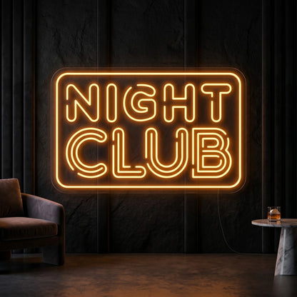 Photo of the 'Night Club' neon sign glowing in golden yellow against a styled interior wall.