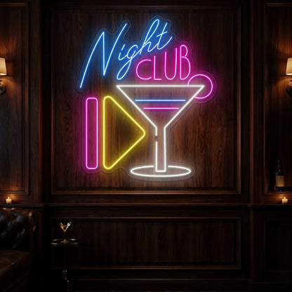 Photo of the 'Night Club' neon sign glowing in multi-color against a styled interior wall.