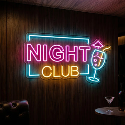 Photo of the 'Night Club' neon sign glowing in multi-color against a styled interior wall.