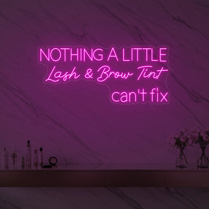 Photo of the 'Nothing a Little Lash & Brow Tint Can’t Fix' neon sign glowing in light pink against a styled interior wall.