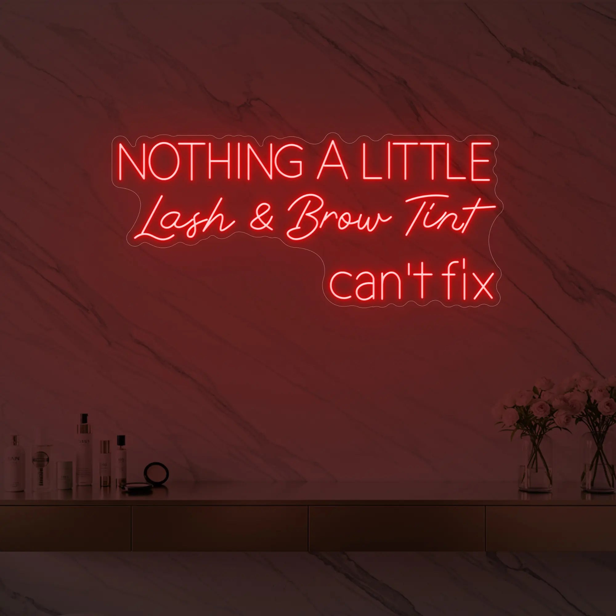 Photo of the 'Nothing a Little Lash & Brow Tint Can’t Fix' neon sign glowing in red against a styled interior wall.