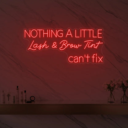 Photo of the 'Nothing a Little Lash & Brow Tint Can’t Fix' neon sign glowing in red against a styled interior wall.