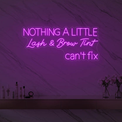 Photo of the 'Nothing a Little Lash & Brow Tint Can’t Fix' neon sign glowing in deep pink against a styled interior wall.