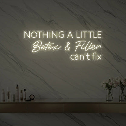 Photo of the 'Nothing a Little Botox & Filler Can’t Fix' neon sign glowing in warm white against a styled interior wall.