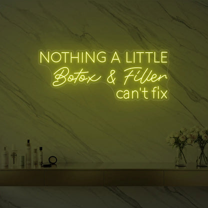 Photo of the 'Nothing a Little Botox & Filler Can’t Fix' neon sign glowing in lemon yellow against a styled interior wall.