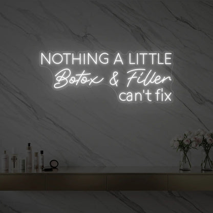 Photo of the 'Nothing a Little Botox & Filler Can’t Fix' neon sign glowing in cool white against a styled interior wall.