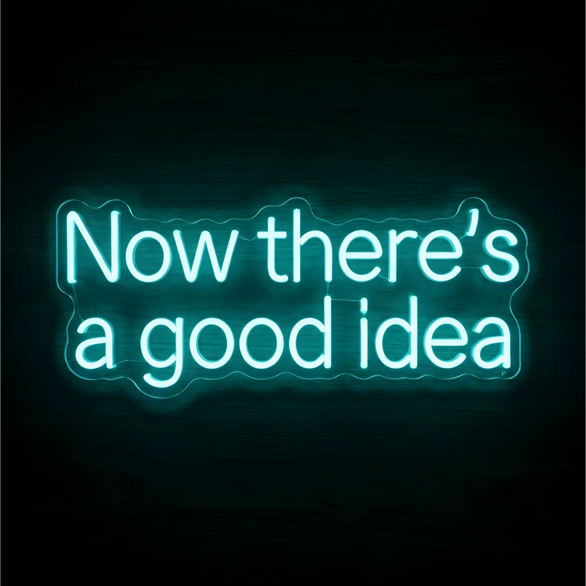 Now there's a good idea LED Neon Sign with bright aqua lettering on clear acrylic against a dark wood background, suited to creative studios and home offices.