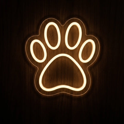 Paw Print LED Neon Sign featuring a warm white glowing paw outline on clear cut-to-shape acrylic backing.