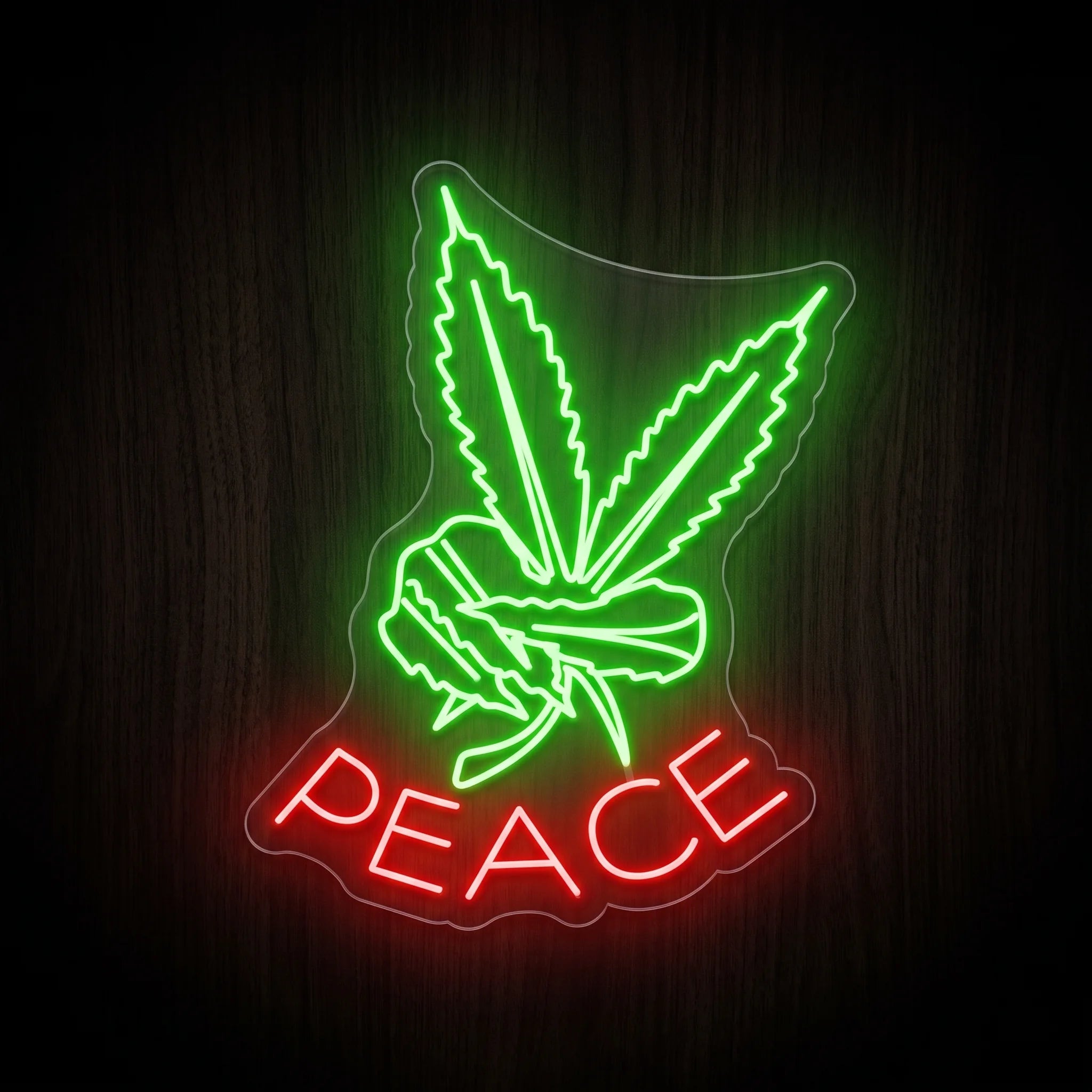 Green cannabis leaf intertwined with a peace symbol above bright red PEACE lettering LED neon sign mounted on a clear acrylic backing.