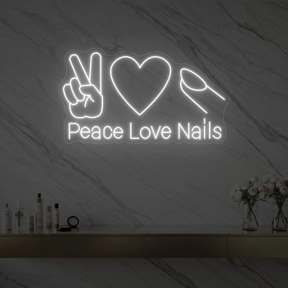 Photo of the 'Peace Love Nails' neon sign glowing in cool white against a styled interior wall.