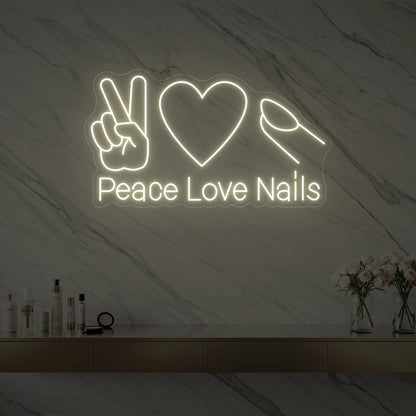 Photo of the 'Peace Love Nails' neon sign glowing in warm white against a styled interior wall.