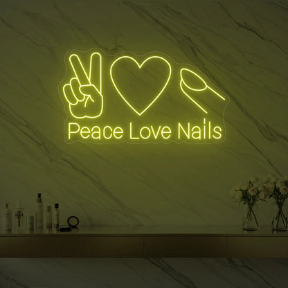 Photo of the 'Peace Love Nails' neon sign glowing in lemon yellow against a styled interior wall.