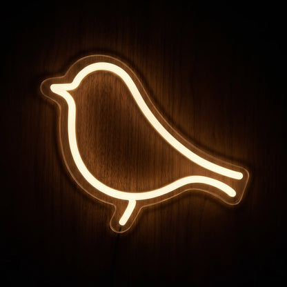 Perched Bird LED neon sign featuring a minimalist bird silhouette glowing in warm white on clear acrylic backing.