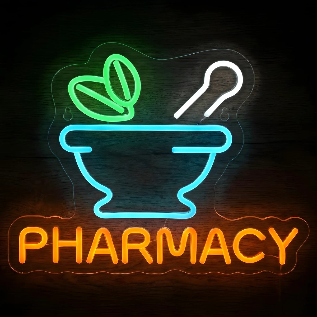 Pharmacy Mortar and Pestle LED Neon Sign featuring a cyan mortar, white pestle, green leaves, and orange PHARMACY lettering on clear cut-to-shape acrylic against a dark wooden wall.